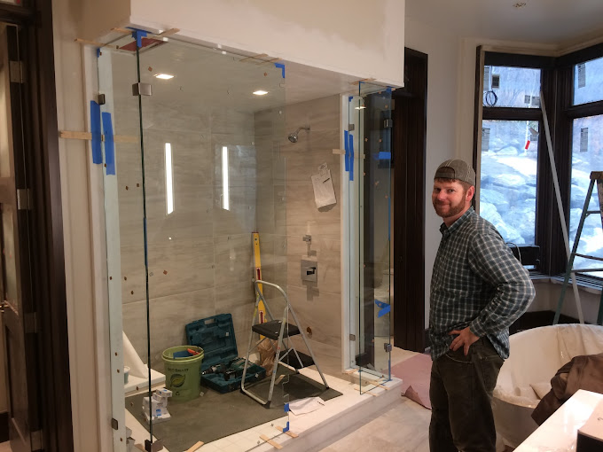 man standing in bathroom with shower under construction